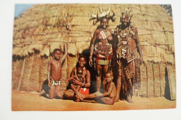African family in front of hut